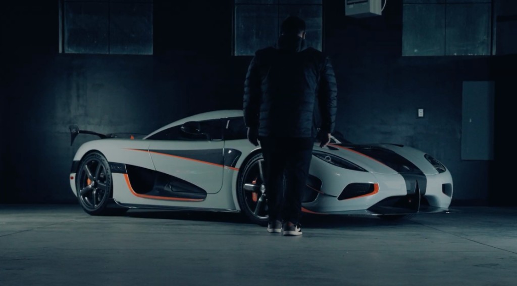 Detailer and PPF installer with a white Koenigsegg in a garage