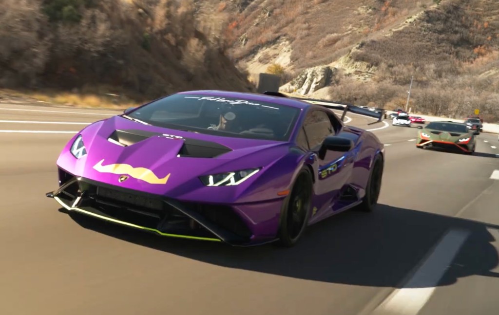Purple Lamborghini Huracán STO with Movember mustache on a canyon highway