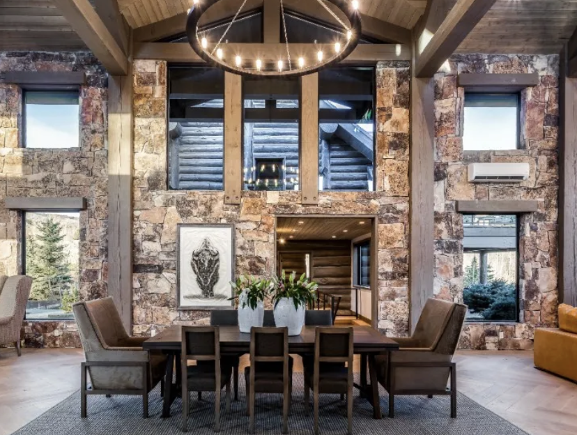 Stone and timber dining room with vaulted ceiling and hoop chandelier
